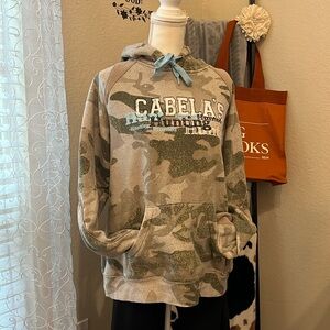 Women’s cool toned camo hoodie with front kangaroo pocket. Pretty LT blue accent